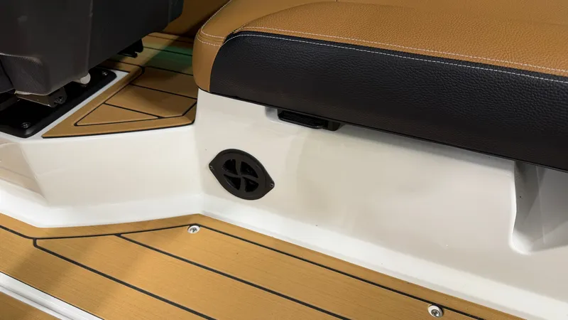 Slide: The Image of Close-up of a 2026 Nautique Super Air Nautique G23 interior with brown seating. - 28