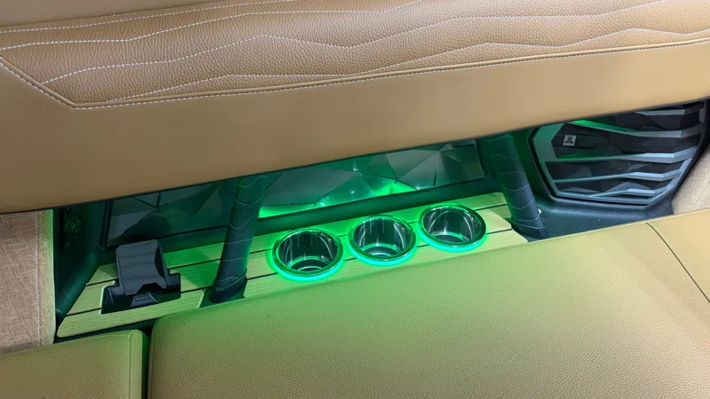 Slide: The Image of Interior of the Nautique Super Air Nautique G23 with illuminated cup holders and luxurious upholstery. - 31