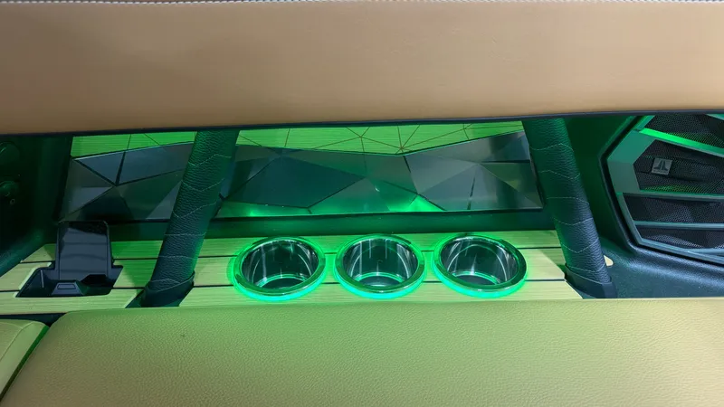 Slide: The Image of Interior of the Nautique Super Air Nautique G23 with illuminated cup holders and modern design. - 33