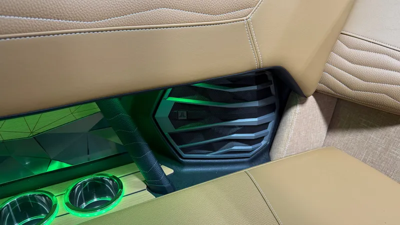 Slide: The Image of Interior of the Nautique Super Air Nautique G23 with sleek seating and green lighting. - 34