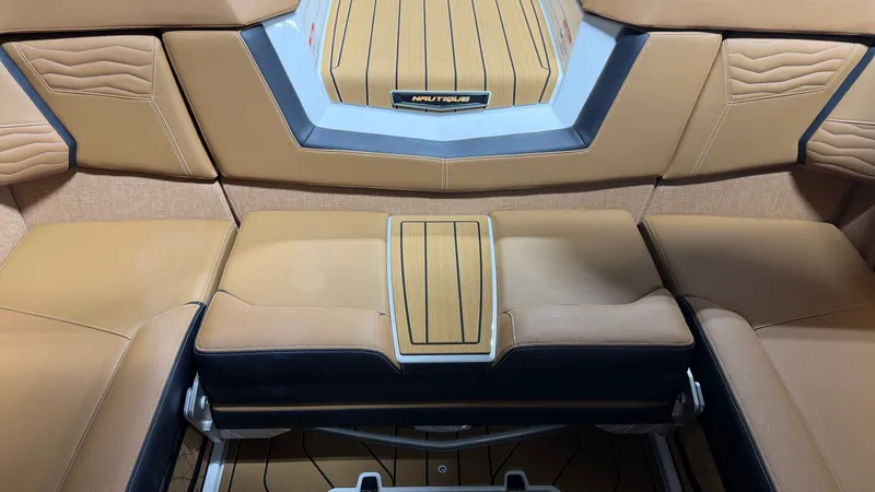 Slide: The Image of Interior view of a Nautique Super Air Nautique G23 with sleek, cushioned seating and wood accents. - 36