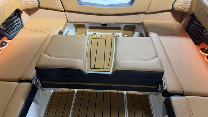 Slide: The Image of Interior of the Nautique Super Air Nautique G23 with brown upholstery and wooden flooring. - 37