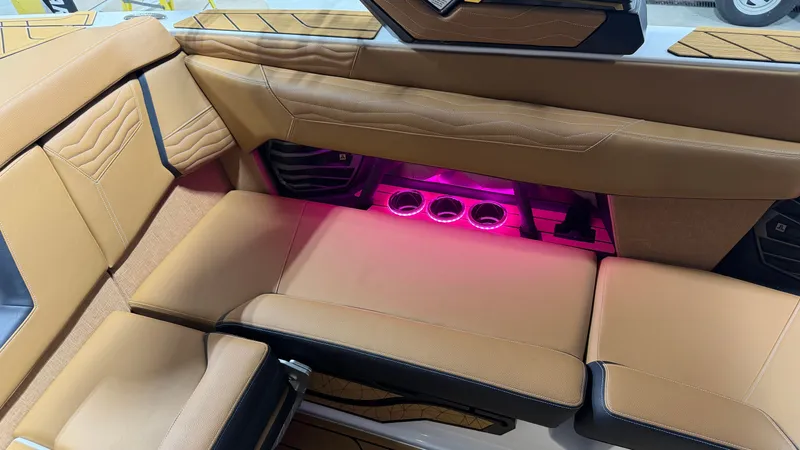 Slide: The Image of Interior of the Nautique Super Air Nautique G23 with beige upholstery and pink lighting. - 39