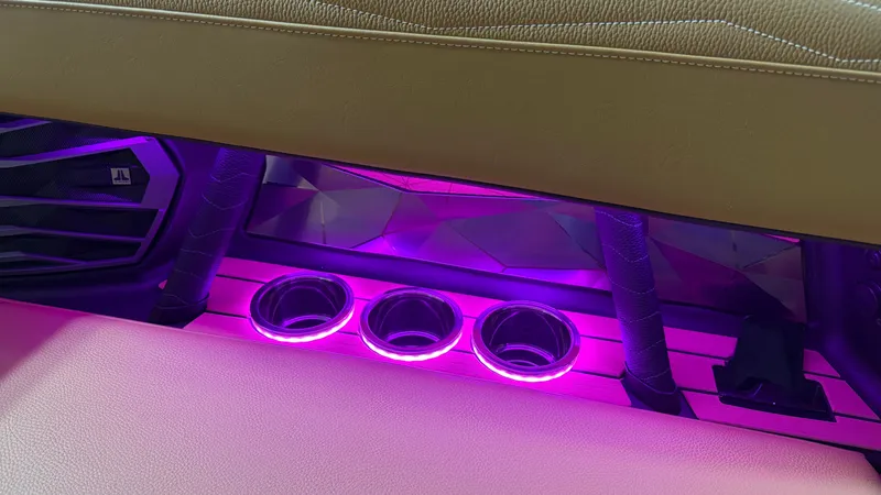 Slide: The Image of Illuminated cup holders in a modern boat with purple LED lighting. - 41