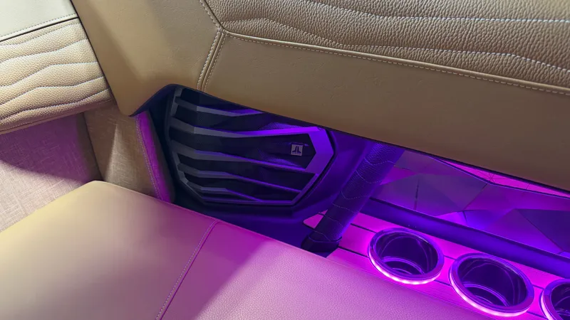 Slide: The Image of Interior of the Nautique Super Air Nautique G23 with purple lighting and cup holders. - 42