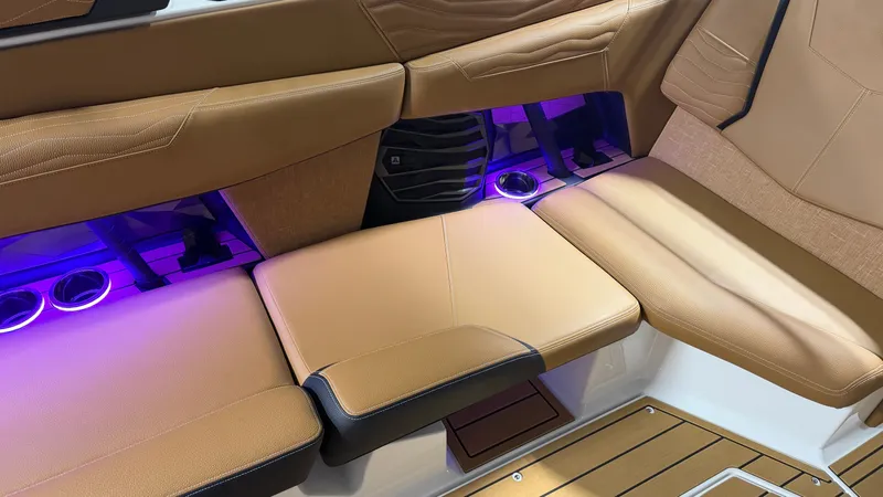 Slide: The Image of Interior of the Nautique Super Air Nautique G23 with brown seats and purple lighting. - 44