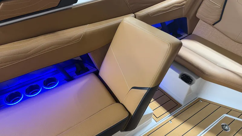 Slide: The Image of Interior of the Nautique Super Air Nautique G23 with brown seats and blue LED lighting. - 45