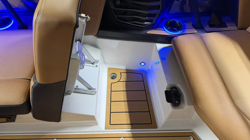 Slide: The Image of Interior of a Nautique Super Air Nautique G23 with brown seats and blue LED lighting. - 46