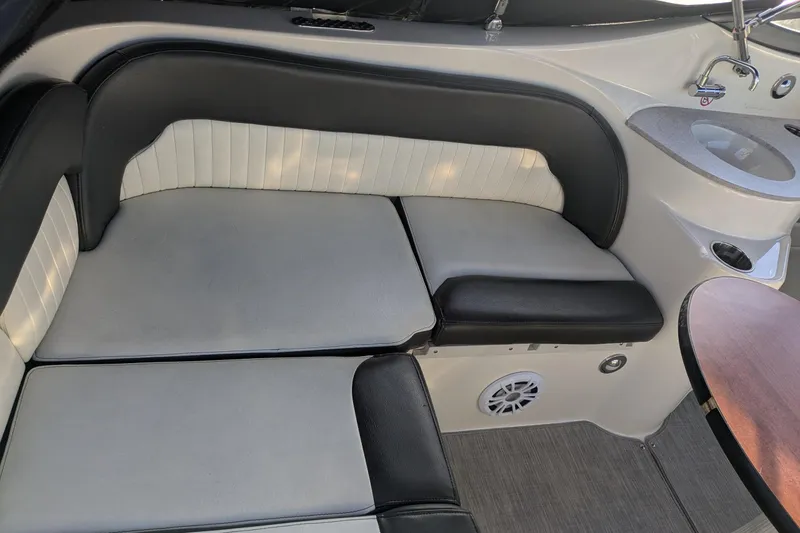 Slide: The Image of 2019 Stingray 250 CR boat interior with cushioned seating and built-in sink. - 10