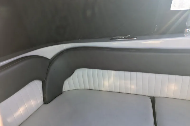 Slide: The Image of 2019 Stingray 250 CR boat interior with gray and white seating. - 11
