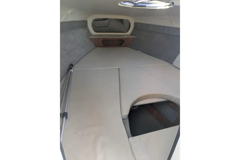 Slide: The Image of 2019 Stingray 250 CR cabin interior with beige cushions and compact design. - 16