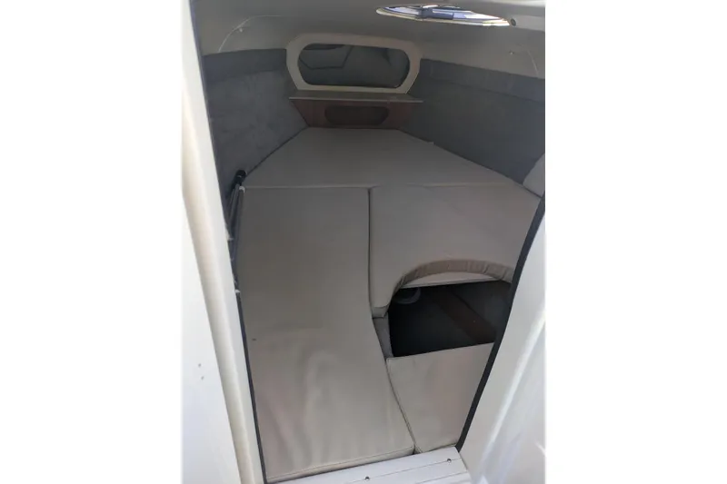 Slide: The Image of 2019 Stingray 250 CR cabin interior with cushioned sleeping area and small window. - 17