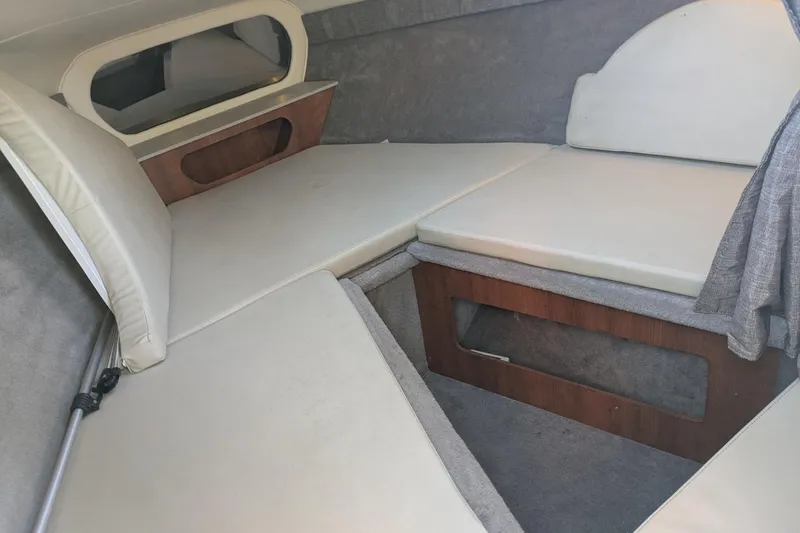 Slide: The Image of 2019 Stingray 250 CR cabin interior with cushioned seating and wooden accents. - 19