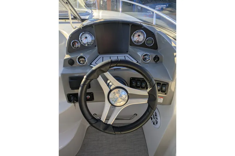 Slide: The Image of 2019 Stingray 250 CR boat dashboard with steering wheel and gauges. - 5