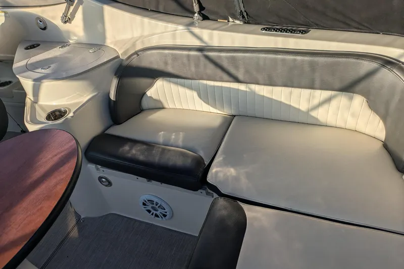 Slide: The Image of 2019 Stingray 250 CR boat interior with cushioned seating and table. - 9