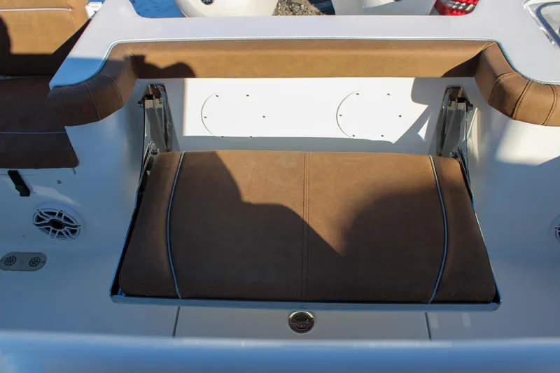 Slide: The Image of 2026 Sea Hunt Gamefish 25 boat seat with brown upholstery and white accents. - 10