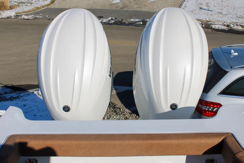 Slide: The Image of 2026 Sea Hunt Gamefish 25 with dual Yamaha outboard engines, parked near a snowy driveway. - 11