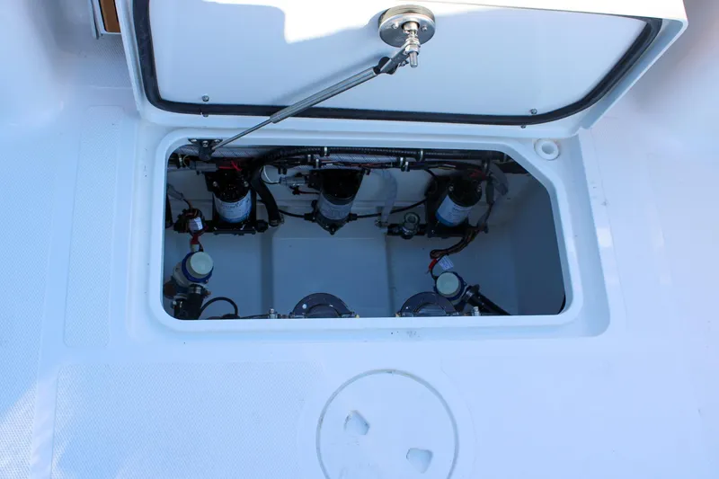 Slide: The Image of 2026 Sea Hunt Gamefish 25 boat compartment with visible mechanical components. - 13