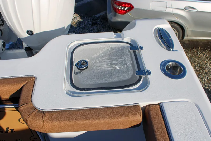 Slide: The Image of 2026 Sea Hunt Gamefish 25 boat deck with storage compartment and cup holders. - 14