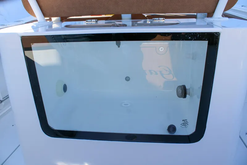 Slide: The Image of 2026 Sea Hunt Gamefish 25 livewell with transparent lid and brown seat. - 16