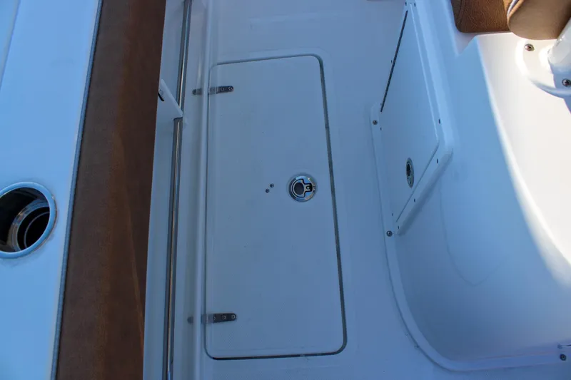 Slide: The Image of 2026 Sea Hunt Gamefish 25 deck with storage compartment and seating area. - 17