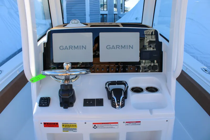 Slide: The Image of 2026 Sea Hunt Gamefish 25 dashboard with dual Garmin displays and modern controls. - 2