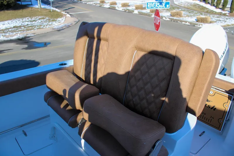 Slide: The Image of 2026 Sea Hunt Gamefish 25 boat seat with brown upholstery and diamond stitching. - 23