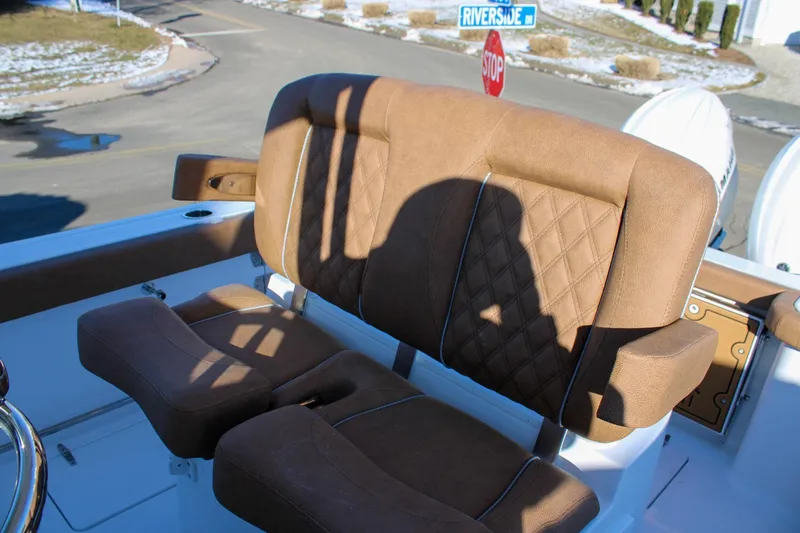 Slide: The Image of Brown leather seating on 2026 Sea Hunt Gamefish 25 boat, with shadow and street signs visible. - 24