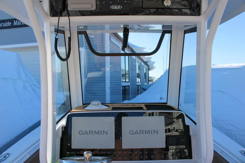 Slide: The Image of 2026 Sea Hunt Gamefish 25 dashboard with dual Garmin displays and marine electronics. - 26