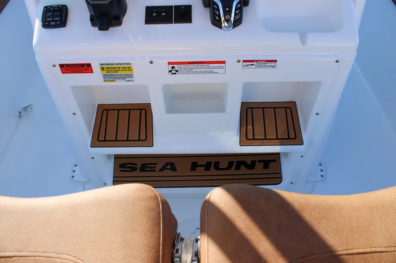 Slide: The Image of 2026 Sea Hunt Gamefish 25 boat console with controls and warning labels. - 27