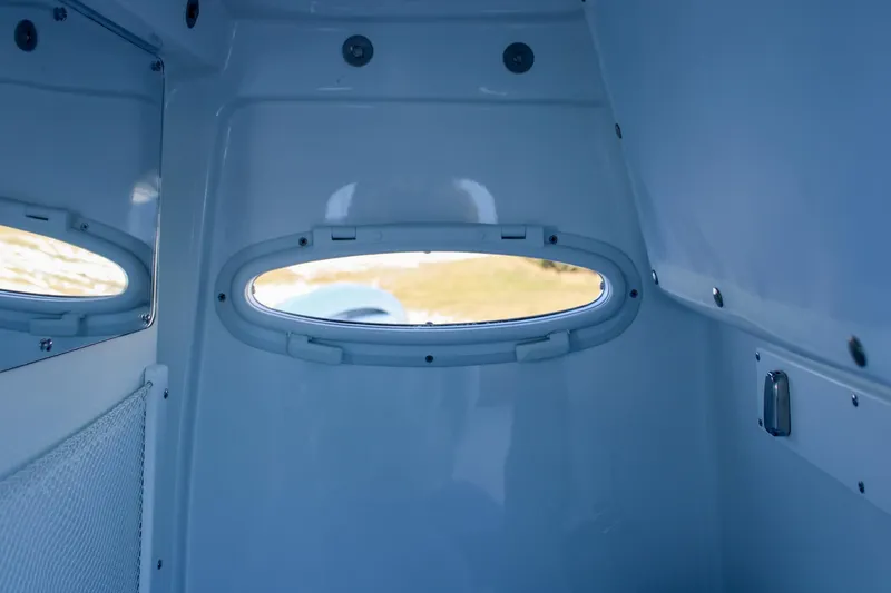 Slide: The Image of Interior view of 2026 Sea Hunt Gamefish 25 boat cabin with oval window. - 34
