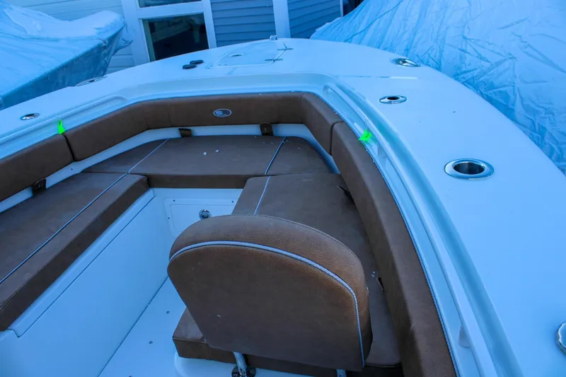 Slide: The Image of 2026 Sea Hunt Gamefish 25 boat interior with brown seating and cup holders. - 36