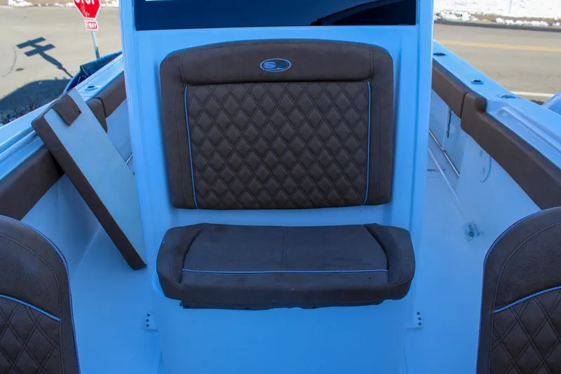 Slide: The Image of 2026 Sea Hunt Gamefish 25 boat interior with brown diamond-stitched seating. - 37