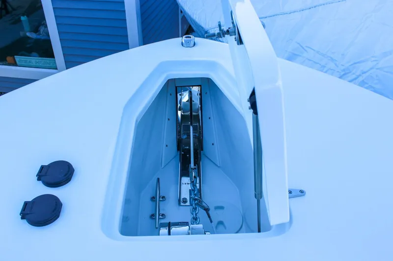 Slide: The Image of Anchor compartment of 2026 Sea Hunt Gamefish 25 boat, open with visible chain. - 40