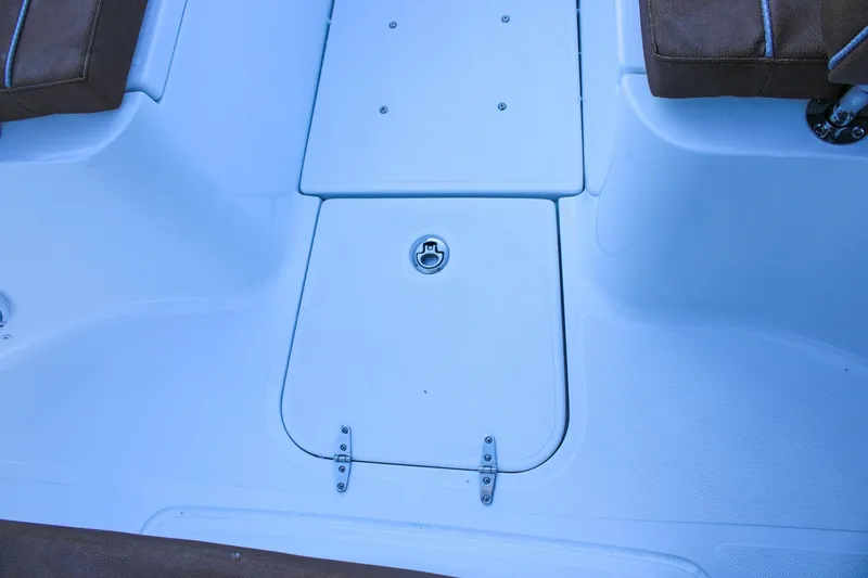 Slide: The Image of 2026 Sea Hunt Gamefish 25 boat deck with storage compartment and brown seating. - 41