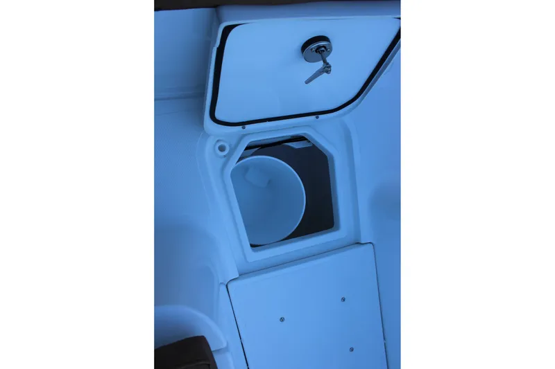 Slide: The Image of 2026 Sea Hunt Gamefish 25 boat storage compartment with open hatch and key. - 42