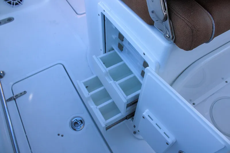 Slide: The Image of 2026 Sea Hunt Gamefish 25 boat with open tackle storage drawers. - 46