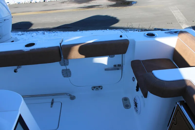 Slide: The Image of 2026 Sea Hunt Gamefish 25 boat interior with cushioned seating and cup holders. - 47