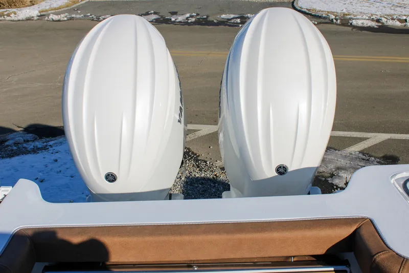 Slide: The Image of Twin outboard engines on a 2026 Sea Hunt Gamefish 25 boat, parked on a snowy day. - 48