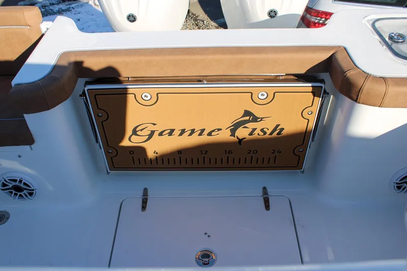 Slide: The Image of 2026 Sea Hunt Gamefish 25 boat interior with brown seating and Gamefish logo. - 5