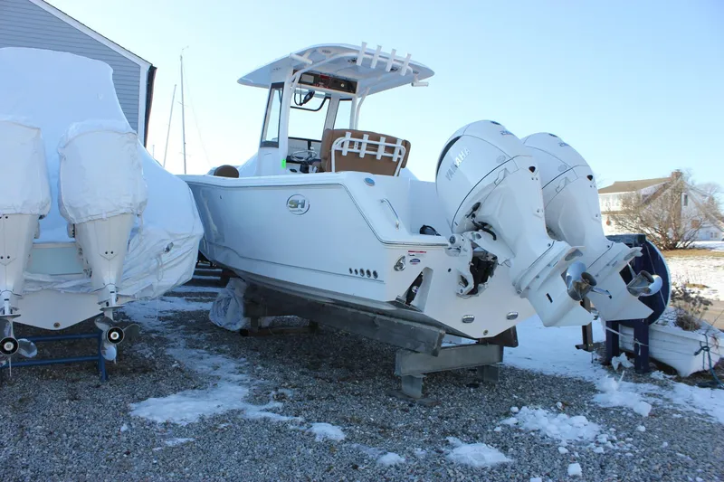 Slide: The Image of 2026 Sea Hunt Gamefish 25 boat with dual Yamaha engines on a snowy lot. - 53
