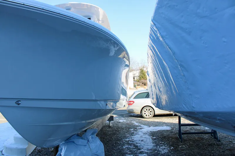 Slide: The Image of 2026 Sea Hunt Gamefish 25 boats in storage, side view with protective covers. - 55