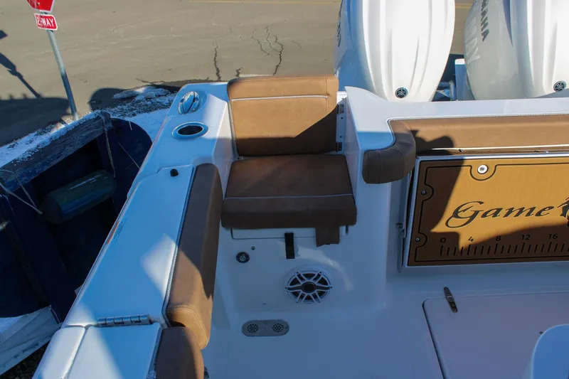 Slide: The Image of 2026 Sea Hunt Gamefish 25 boat interior with brown seating and Yamaha engines. - 7