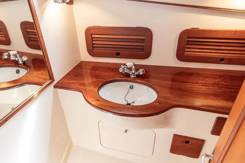 Slide: The Image of 2005 Hinckley Picnic Boat EP bathroom with wooden countertop and sink. - 13