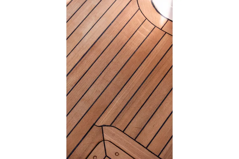 Slide: The Image of Teak deck of 2005 Hinckley Picnic Boat EP, showcasing elegant wood craftsmanship. - 14