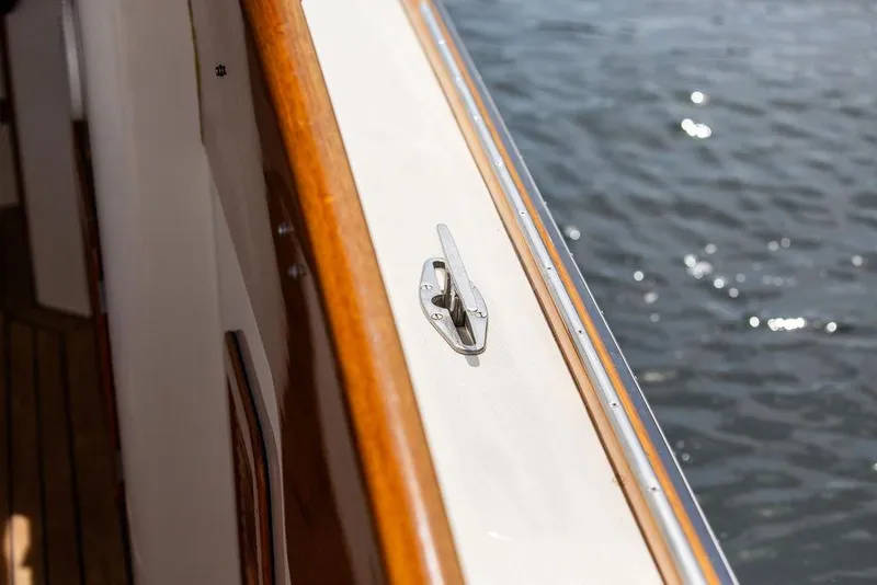 Slide: The Image of 2005 Hinckley Picnic Boat EP deck detail with polished wood and water view. - 15