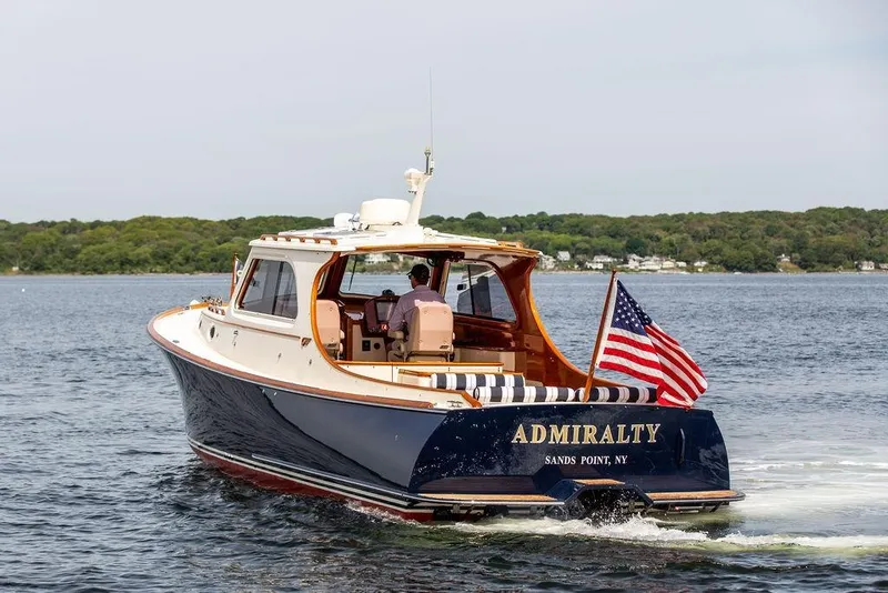 Slide: The Image of 2005 Hinckley Picnic Boat EP cruising on water with American flag. - 4