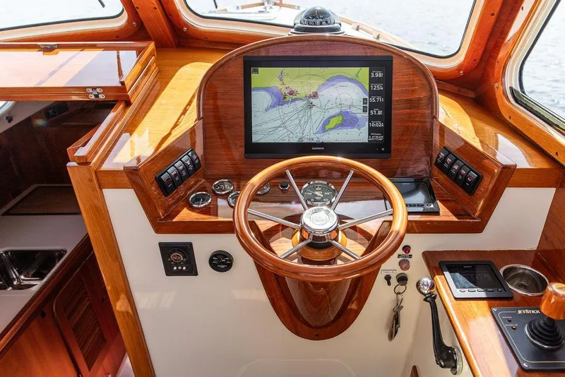 Slide: The Image of 2005 Hinckley Picnic Boat EP helm with GPS navigation and wooden steering wheel. - 8
