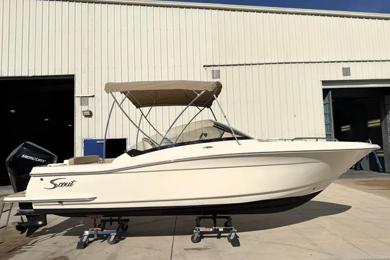 The Image of 2023 Scout 215 Dorado boat with canopy, parked outside a warehouse. - 0