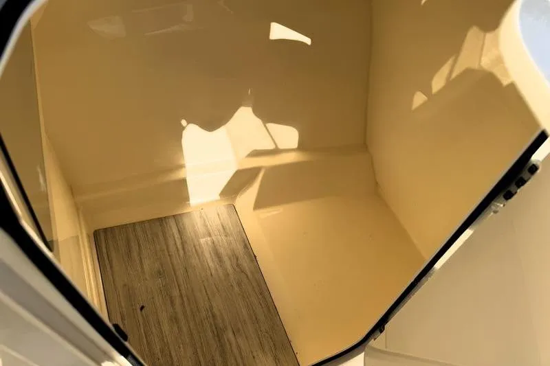 Slide: The Image of 2023 Scout 215 Dorado interior cabin with wood flooring and beige walls. - 14